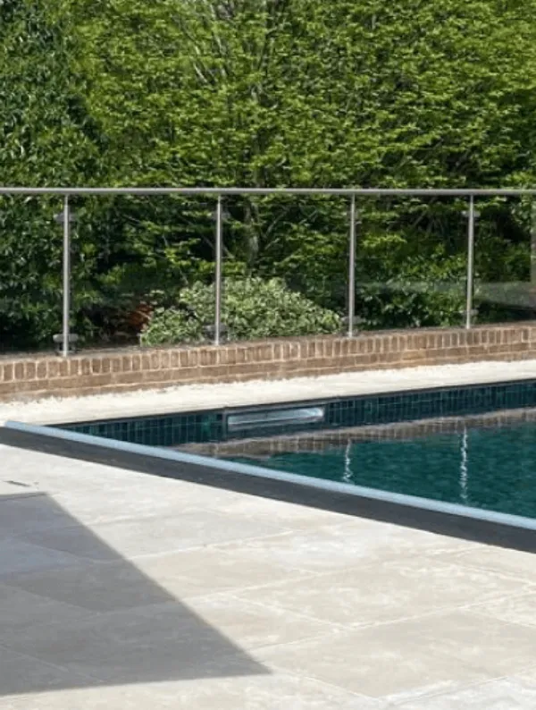 Poolcraft Ltd - luxury outdoor inground pool with sandstone tile surround and automatic pool cover