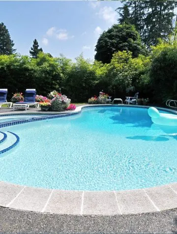 Poolcraft Ltd - An luxury outside freeform pool with roman style steps into the pool