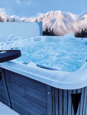 Poolcraft Ltd - Waterwaves series 5 spa outside with a view of snowy mountains